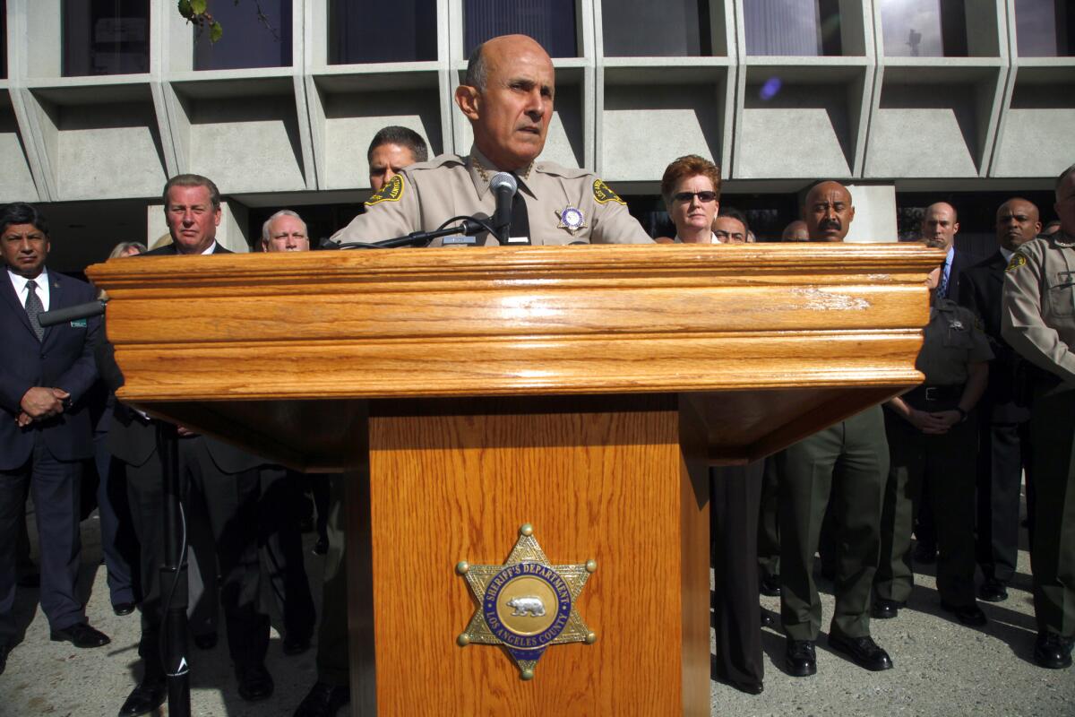 With his command staff standing behind him, Los Angeles County Sheriff Lee Baca announces he will not seek a fifth term.