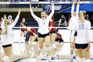 San Diego, CA - December 02: University of San Diego's Breana Edwards (14), center, and teammates celebrate a point scored against Washington State during a second-round match of the NCAA women's volleyball tournament at the Jenny Craig Pavilion on Friday, Dec. 2, 2022 in San Diego, CA. (Meg McLaughlin / The San Diego Union-Tribune)
