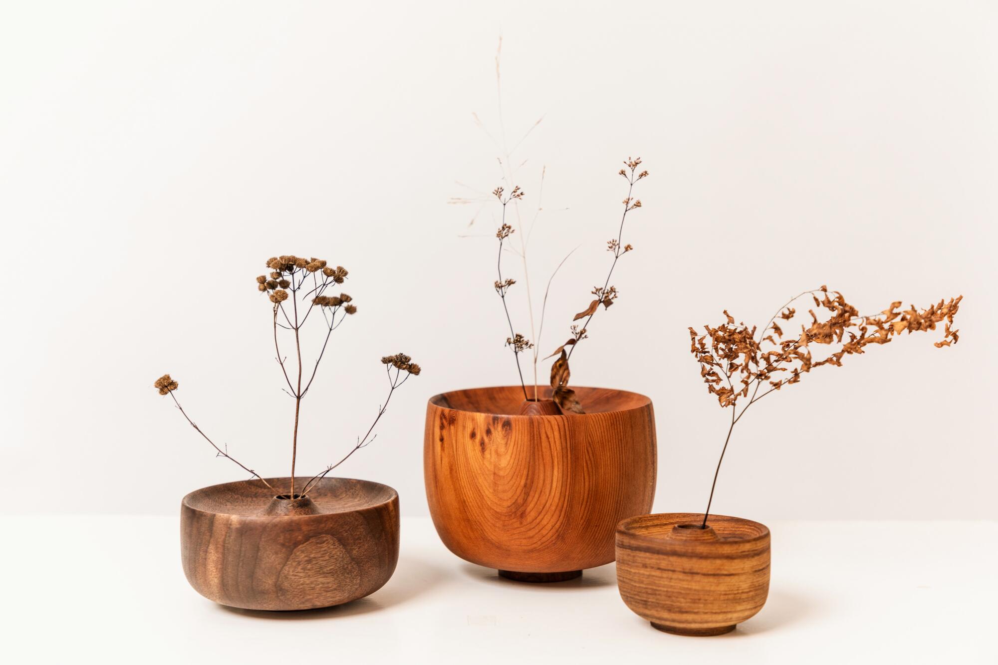Wood vases with dried flowers.