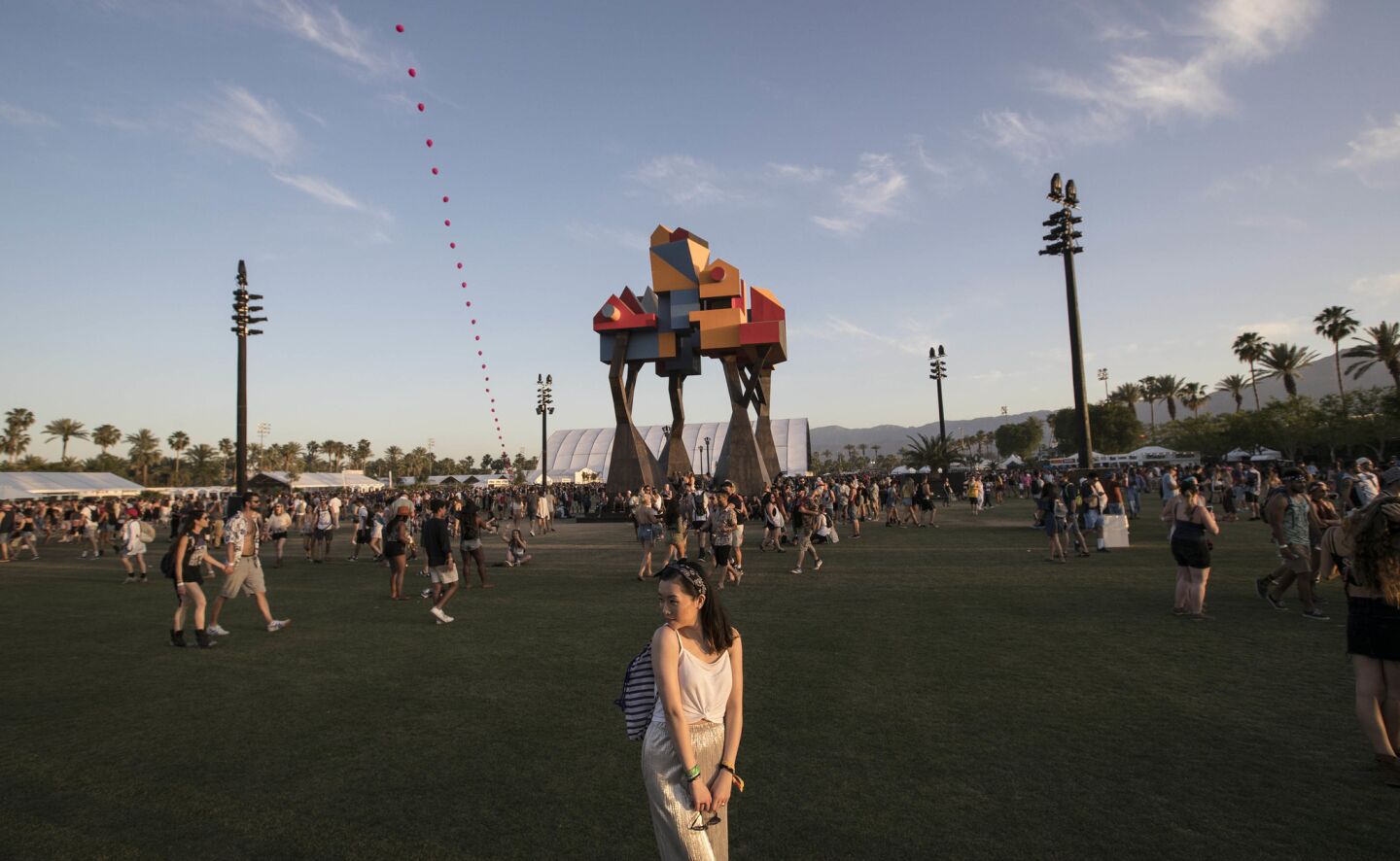 INDIO, CALIF. -- SATURDAY, APRIL 15, 2017: Art installation 'Crown Ether' provides a backdrop for photos at sunset on day two at the Coachella Music and Arts Festival in Indio, Calif., on April 15, 2017. (Brian van der Brug / Los Angeles Times)
