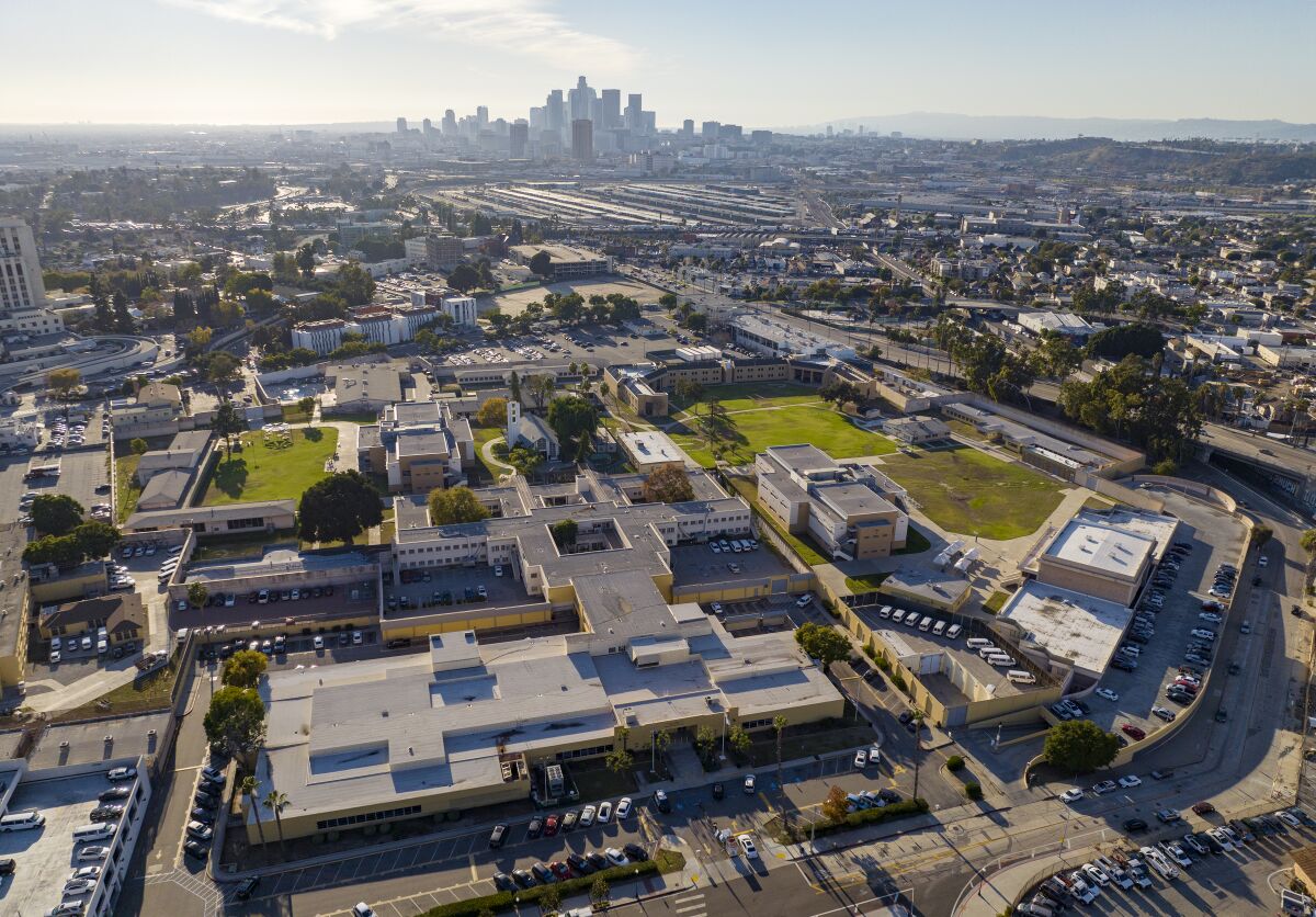 overhead view of a large facility with the L.A. skyline in the background