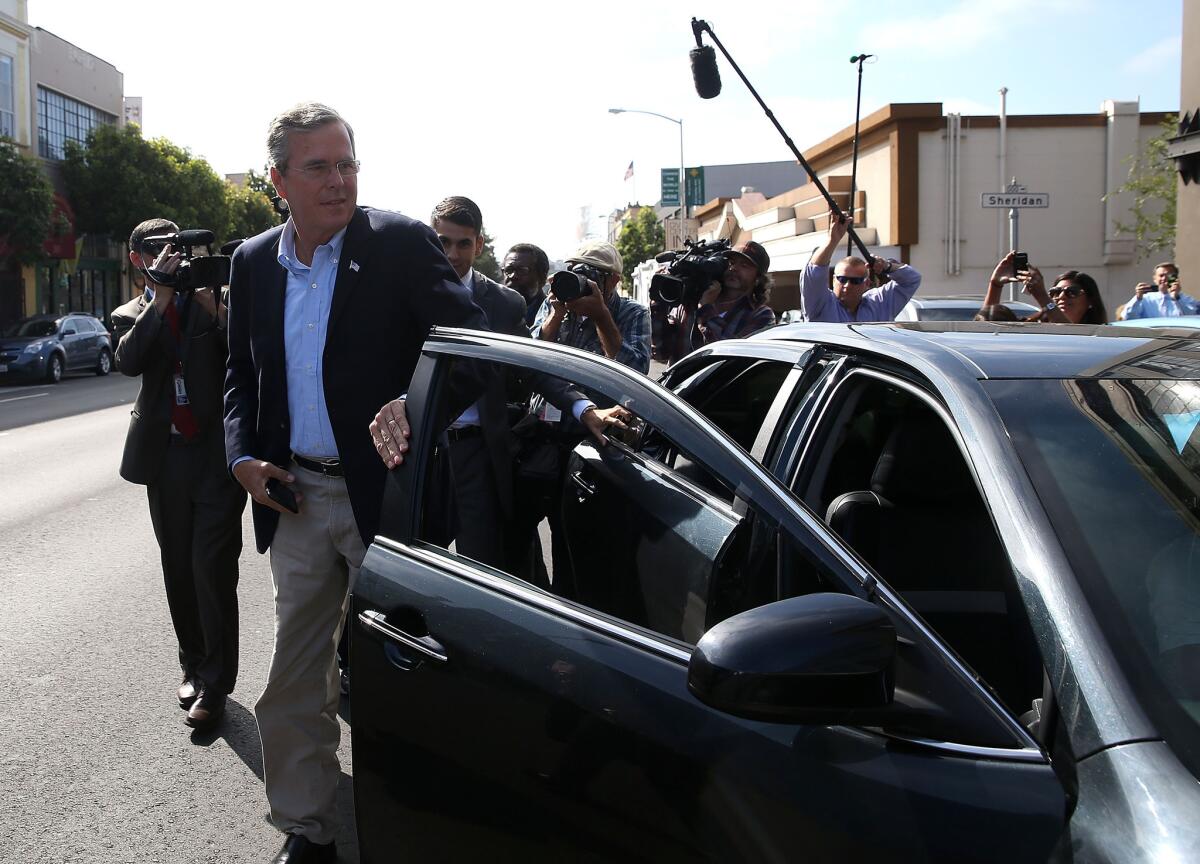 Republican presidential candidate Jeb Bush gets out of an Uber car as he arrives at a campaign stop in San Francisco.