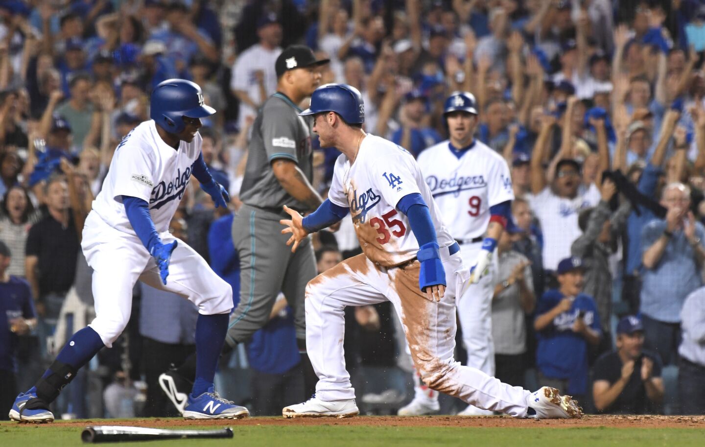Cody Bellinger celebrates with Curtis Granderson, left, after scoring a run in the first inning on a Yasiel Puig double during the first inning of Game 1 of the National League division series.
