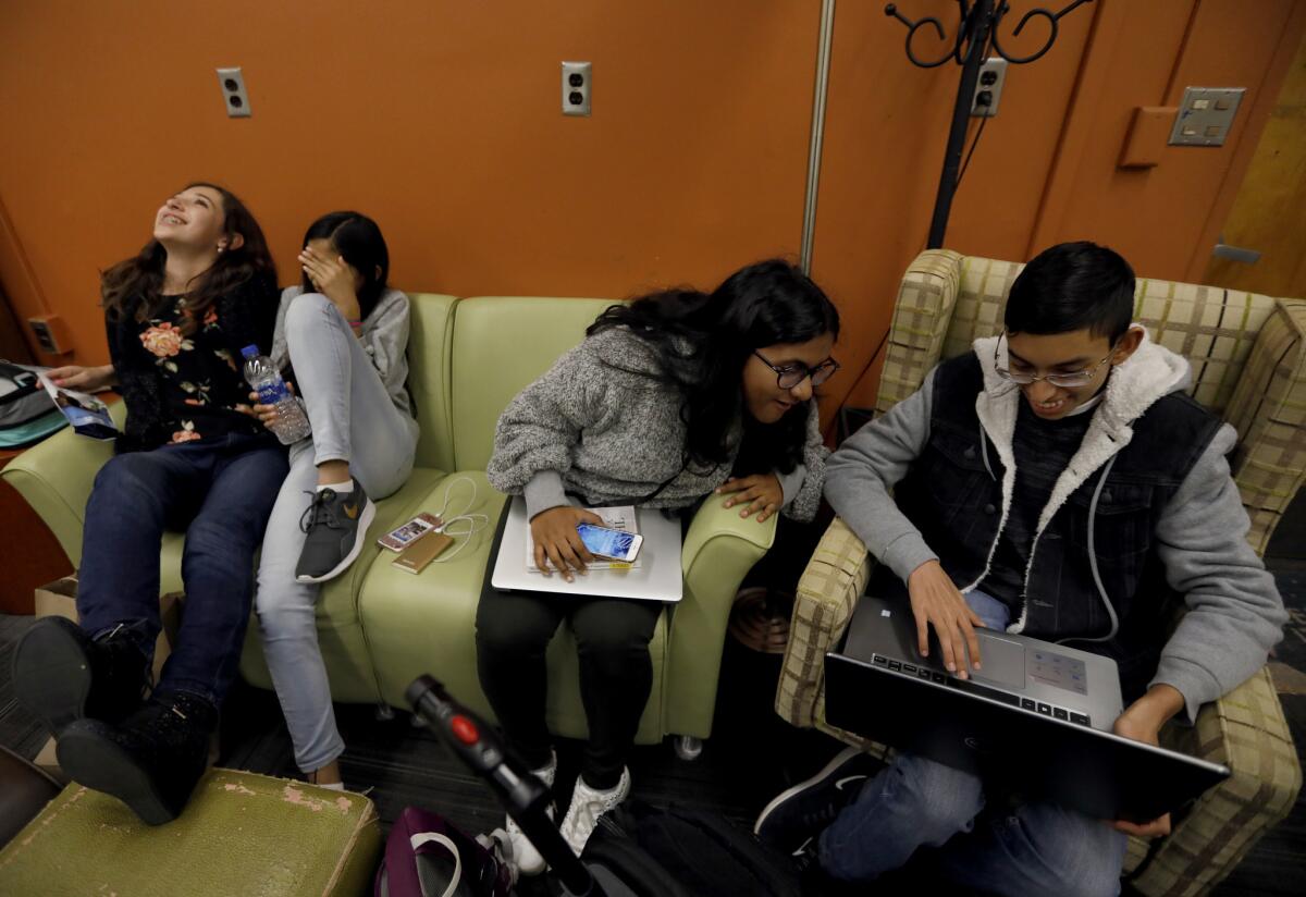 From left, Cal State L.A. students Mia Turel, 13, Shanti Raminani, 12, Annsana Biju, 14, and Viknes Muralitharan, 15, after lunch on campus. (Francine Orr / Los Angeles Times)