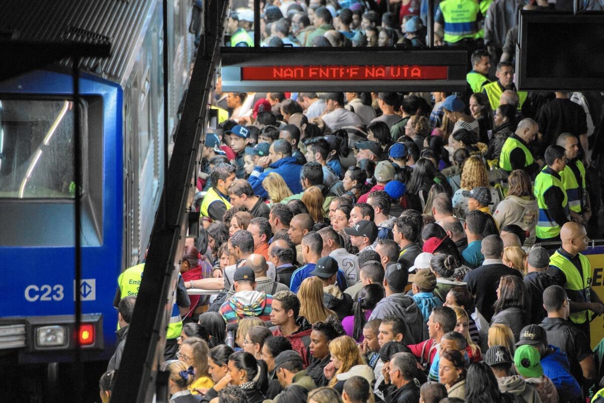 Evening riders try to board a train in Sao Paulo, Brazil. A 2013 report said the city’s average commute time was 43 minutes; it was 28 in Los Angeles.