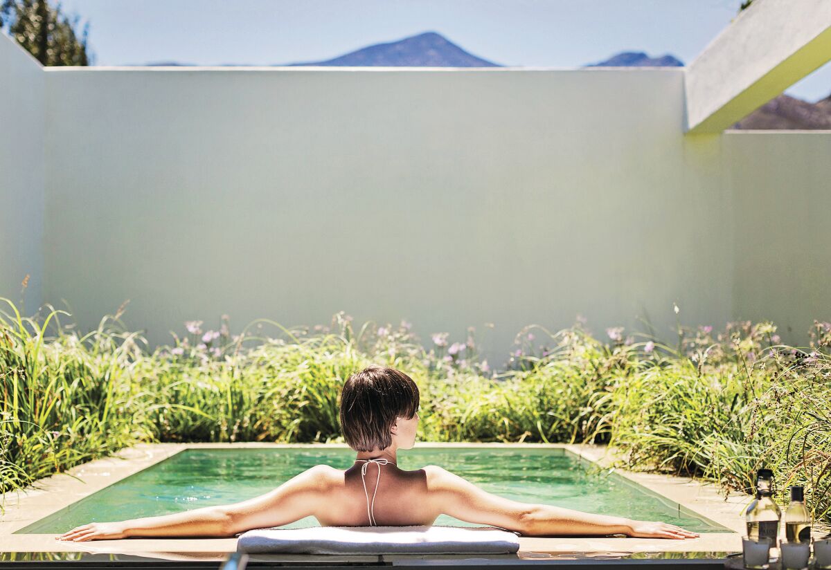 Woman relaxing in small size plunge pool.