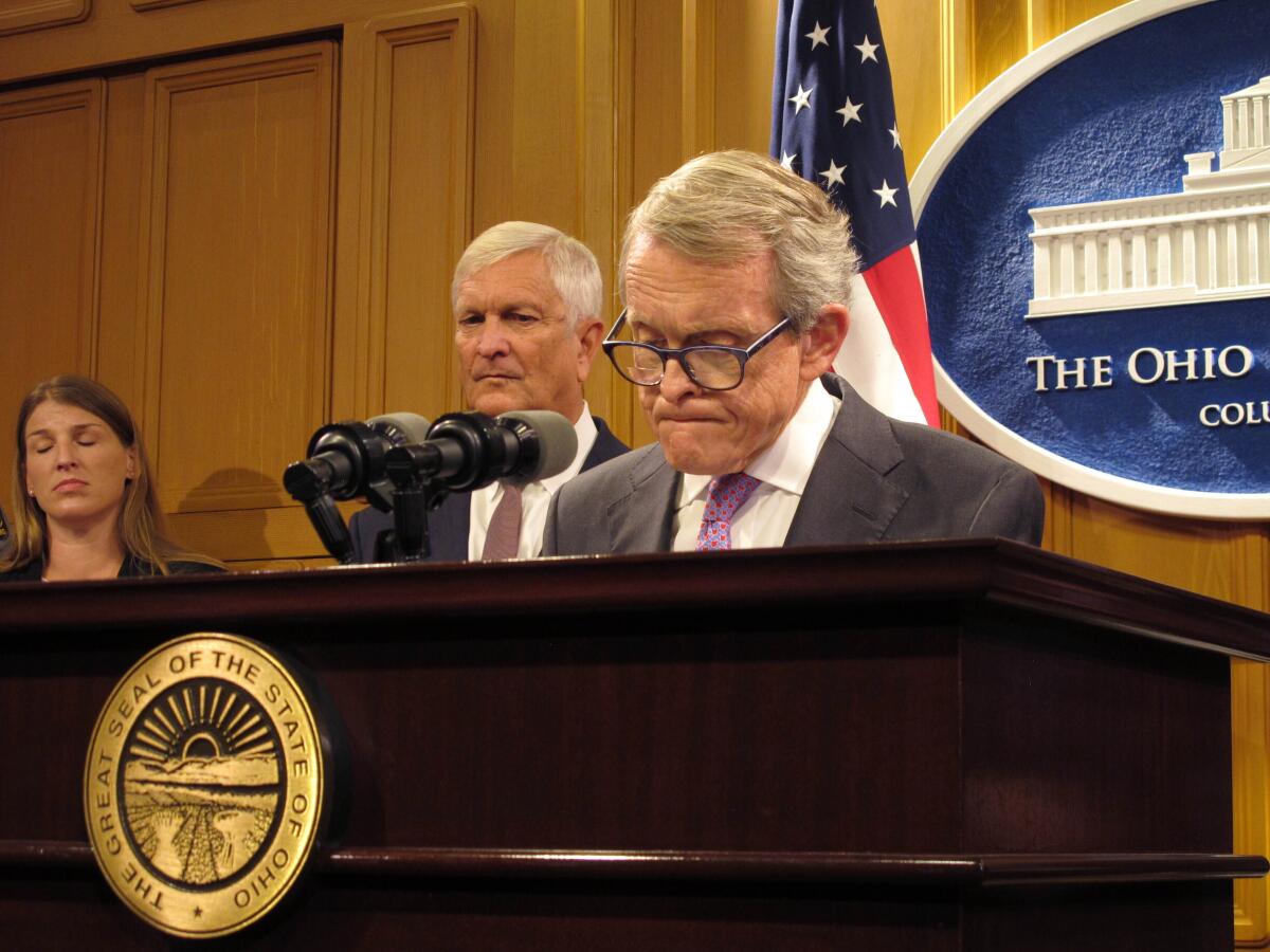 Ohio Gov. Mike DeWine, right, and state Public Safety Director Tom Stickrath speak at a news conference Aug. 30 in Columbus.