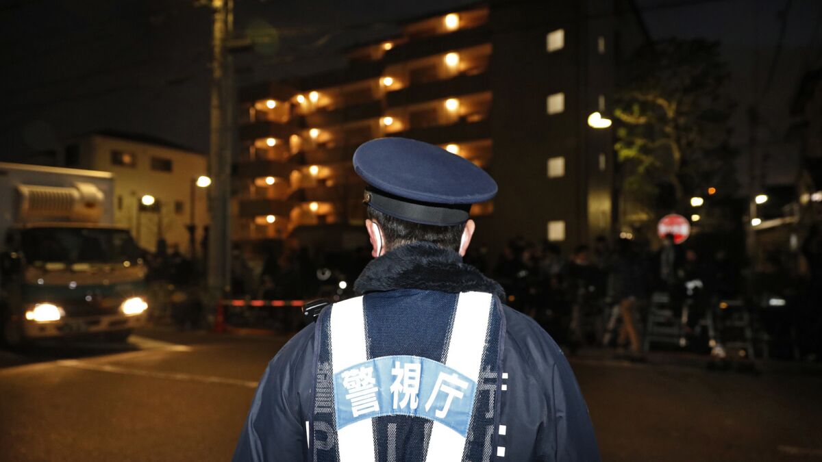 A police officer guards the entrance of the Tokyo Detention Center where former Nissan chairman Carlos Ghosn was being detained in Tokyo a year ago.