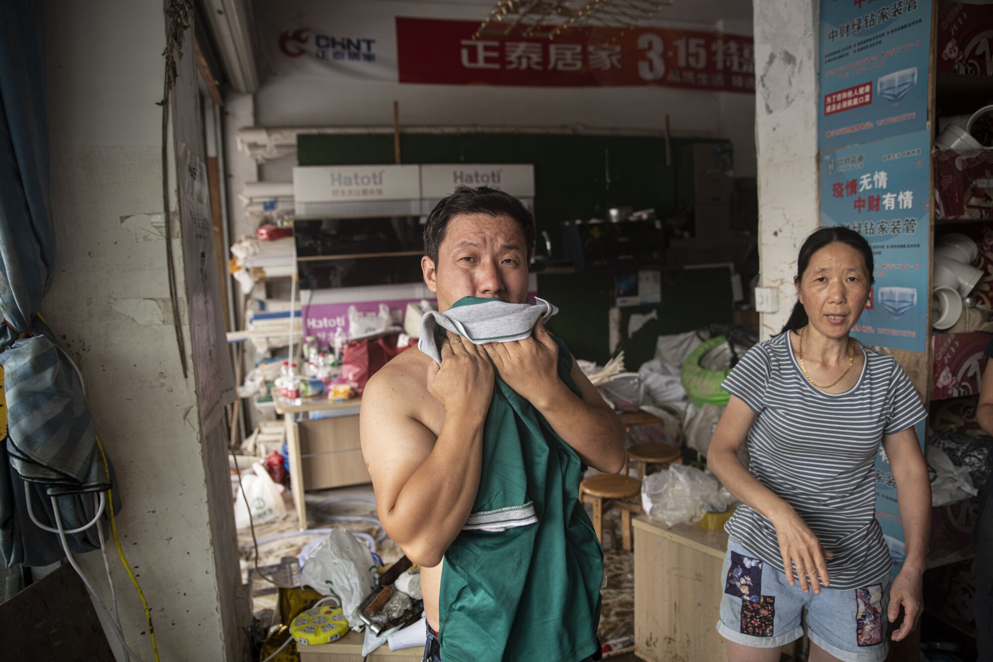 Members of the Shao family in Shexian, Anhui province, are still trying to clean up their store.