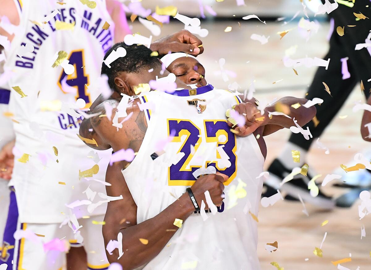 -Lakers LeBron James and Rajon Rondo embrace after winning the NBA Championship