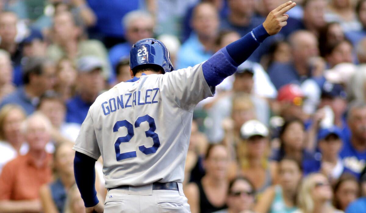 Dodgers first baseman Adrian Gonzalez celebrates after doubling and scoring on a hit by Matt Kemp against the Brewers in the fifth inning Sunday afternoon in Milwaukee.