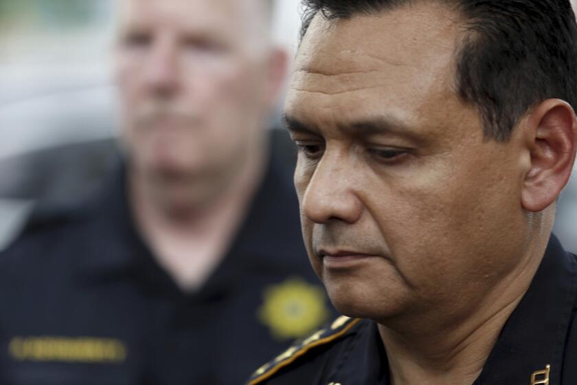 FILE - Harris County Sheriff Ed Gonzalezs pauses as outside a hospital, announcing the identity of the slain Harris County Sheriff's office deputy as Sandeep Dhaliwal in Houston on Sept. 27, 2019. Gonzales has withdrawn from consideration for Immigration and Customs Enforcement director. (Brett Coomer/Houston Chronicle via AP)
