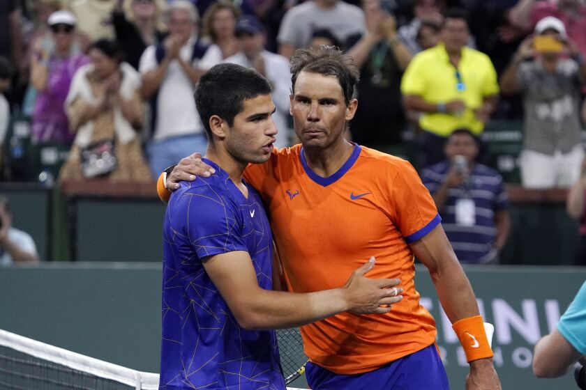 FILE - Rafael Nadal, of Spain, right, greets compatriot Carlos Alcaraz after defeating him in the men's singles semifinals at the BNP Paribas Open tennis tournament Saturday, March 19, 2022, in Indian Wells, Calif. Teenager Carlos Alcaraz is the youngest year-end No. 1 in the history of the ATP computerized rankings. He joins fellow Spaniard Rafael Nadal as the first players from the same country to claim the top two spots at the close of a season since Americans Pete Sampras and Michael Chang did it in 1996.(AP Photo/Mark J. Terrill, File)