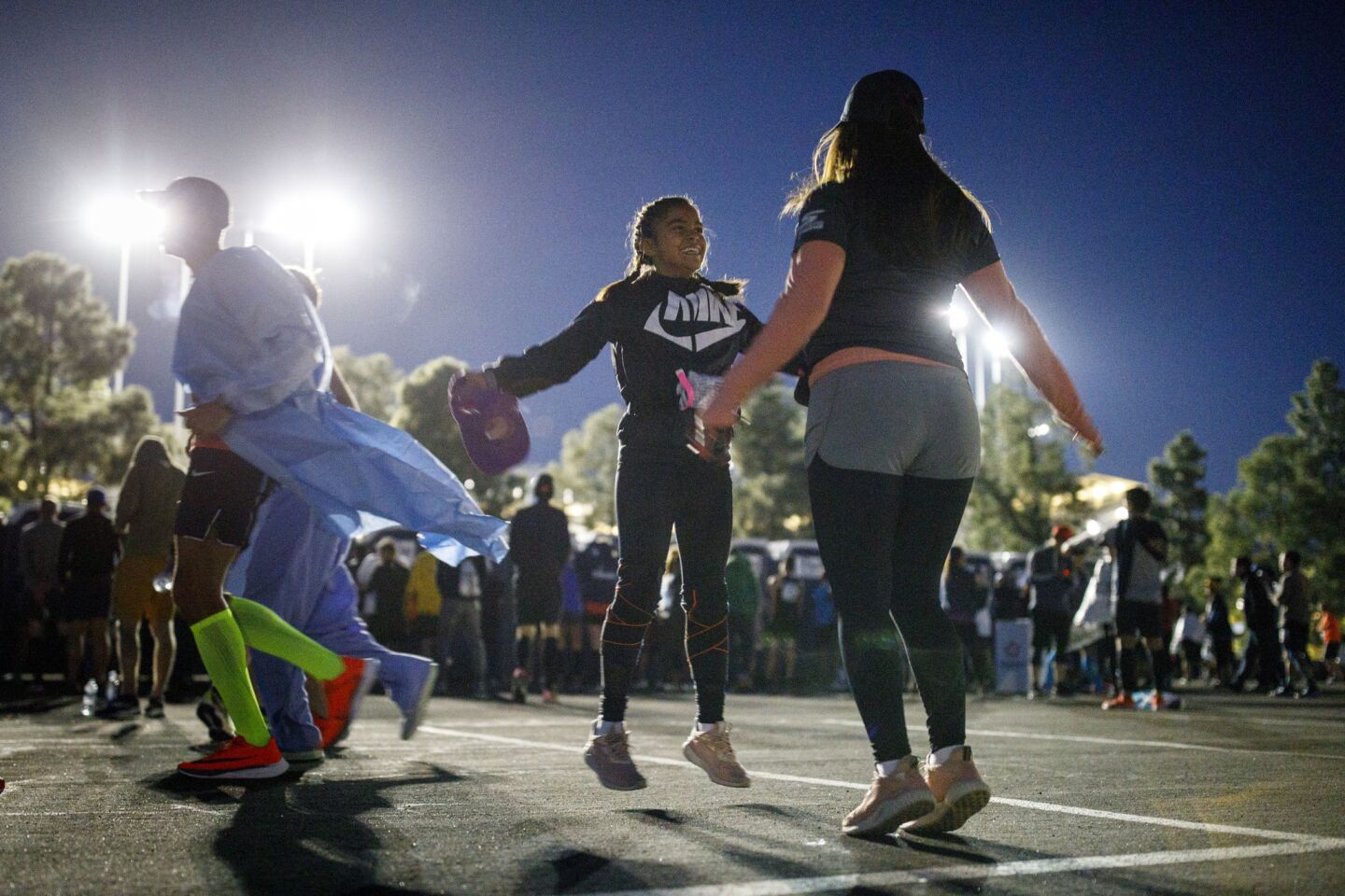 Warming up for the L.A. Marathon, sisters Nelida and Erika Luna do jumping jacks near the start at Dodger Stadium on March 18.