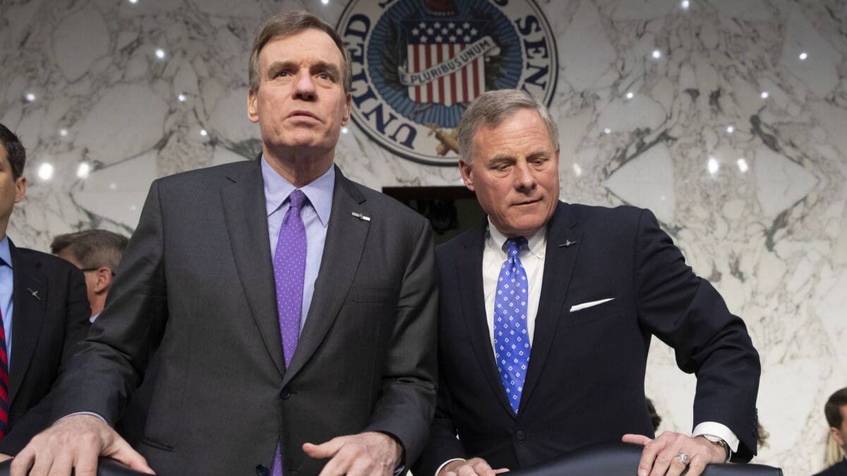 Sen. Mark Warner (D-Va.), left, and Sen. Richard Burr (R-N.C.), the vice chairman and chairman, respectively, of the Senate Intelligence Committee, are both supporting Gina Haspel's nomination to lead the CIA.