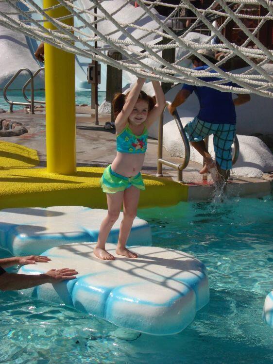 My daughter attempts to cross the iceberg walk at Disney's Blizzard Beach.