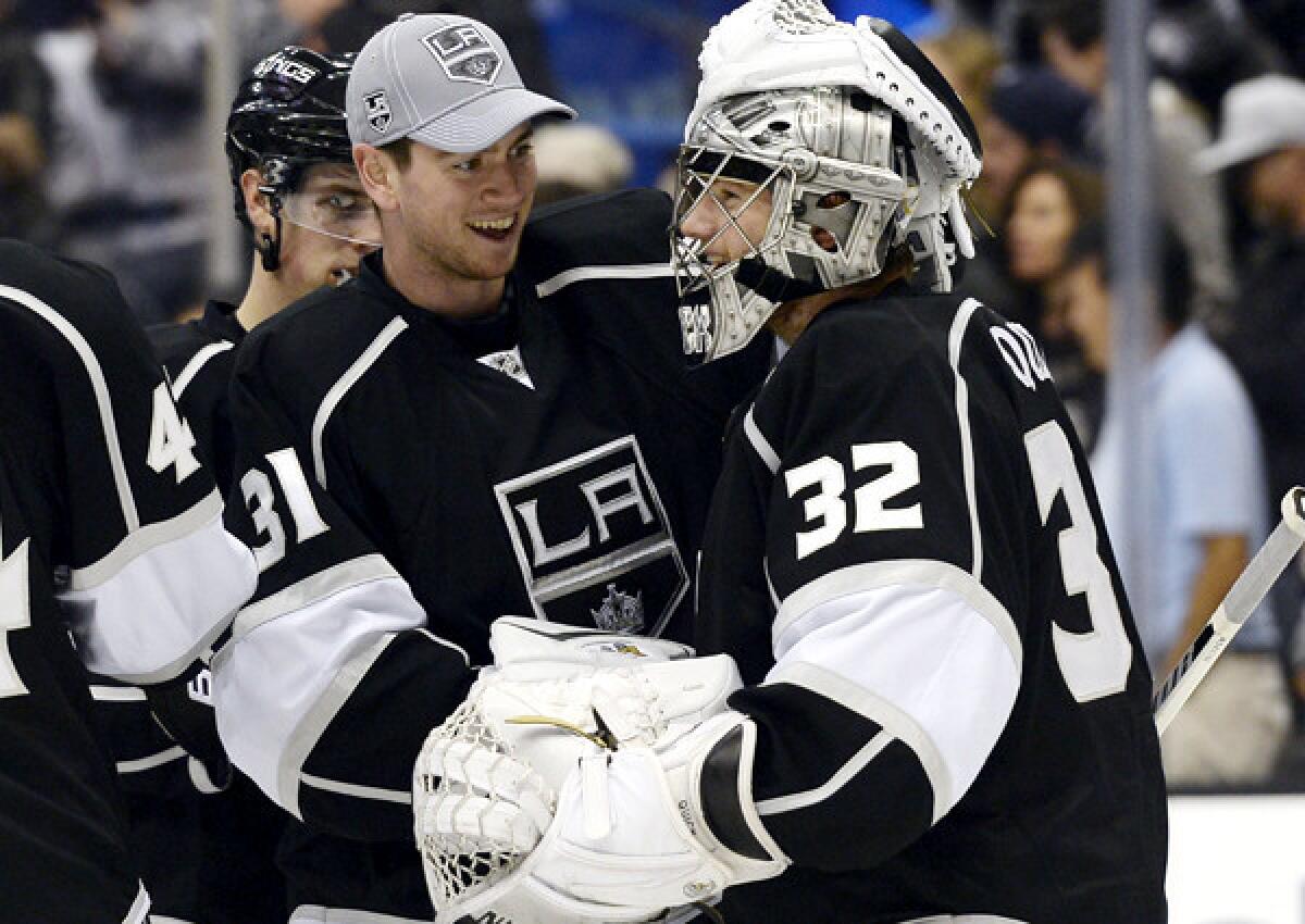 Kings goaltender Jonathan Quick (32) celebrates with backup goalie Martin Jones after a 4-2 victory over the Winnipeg Jets on Saturday night at Staples Center.
