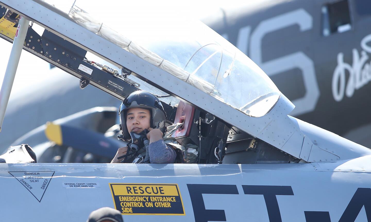 Daily Pilot reporter Priscella Vega prepares to fly in a Lockheed T-33 on Wednesday with jet pilot Greg "Wired" Colyer to see what it would be like to fly in this weekend's Great Pacific Airshow in Huntington Beach.