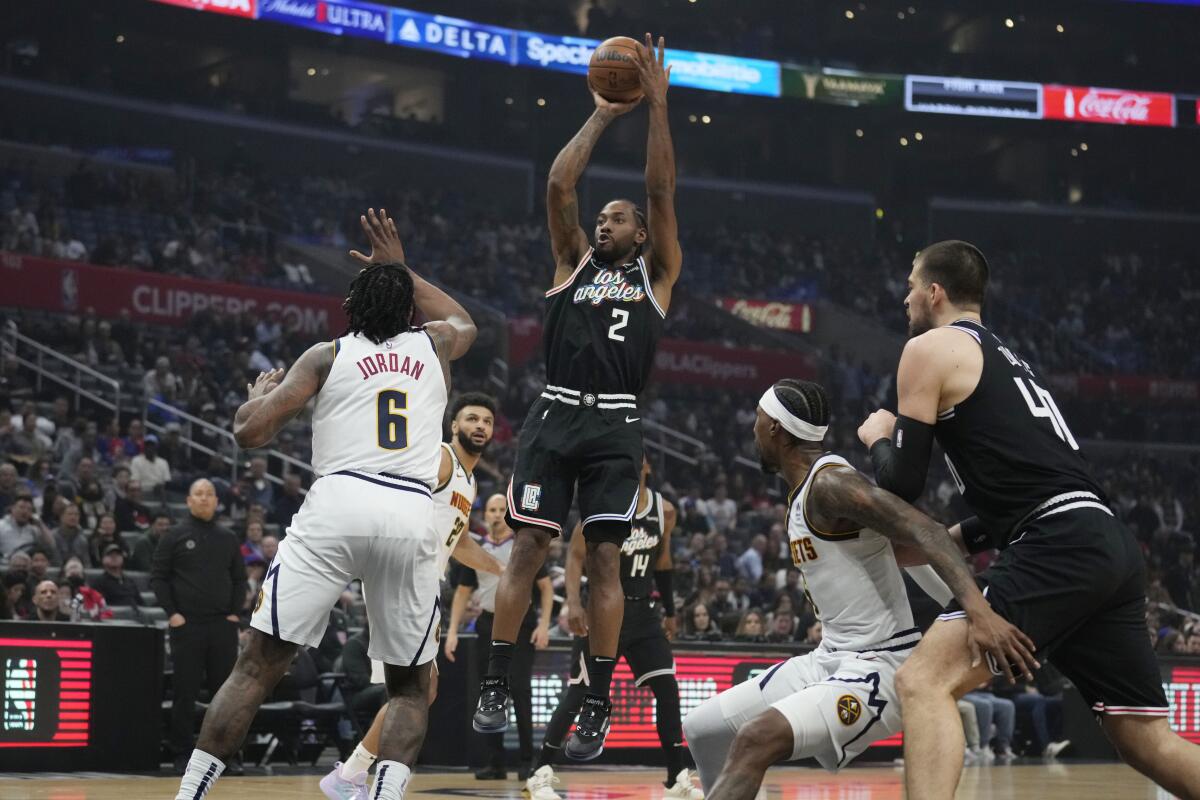 Clippers forward Kawhi Leonard shoots against the Denver Nuggets in the first quarter.