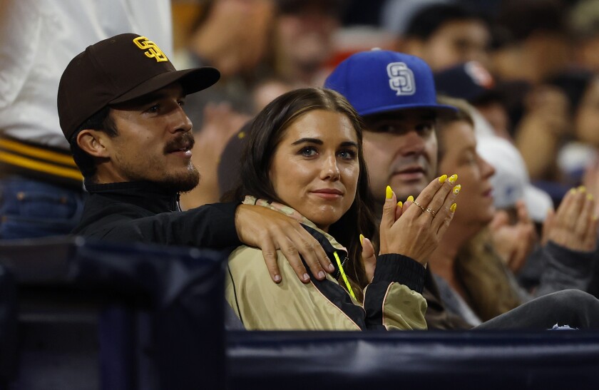 San Diego Wave FC player Alex Morgan and her husband Servando Carrasco watch the Padres last month at Petco Park.