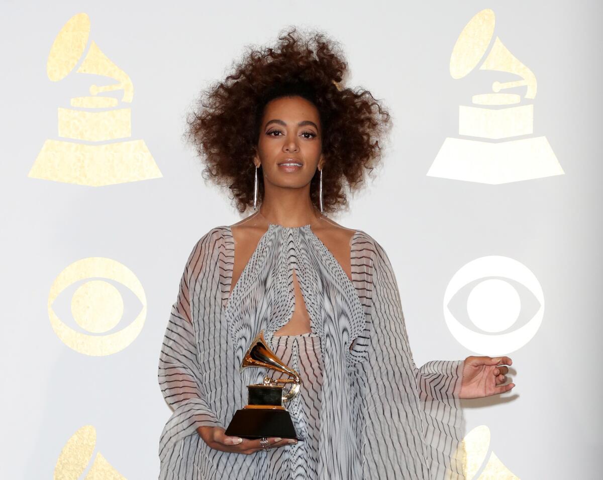 Singer Solange Knowles, winner of best R&B performance for "Cranes in the Sky," poses in the press room during The 59th Grammy Awards at Staples Center on Sunday in Los Angeles..