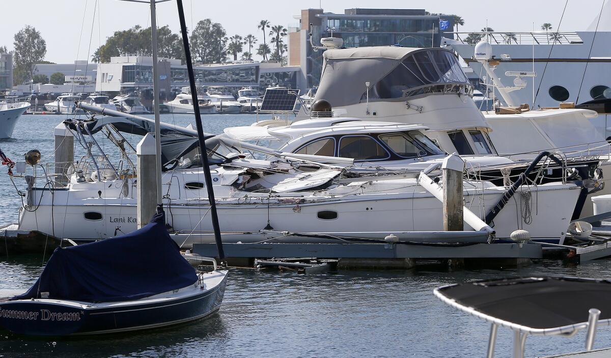 A damaged yacht docked at A'maree's in Newport Harbor in Newport Beach on Thursday.