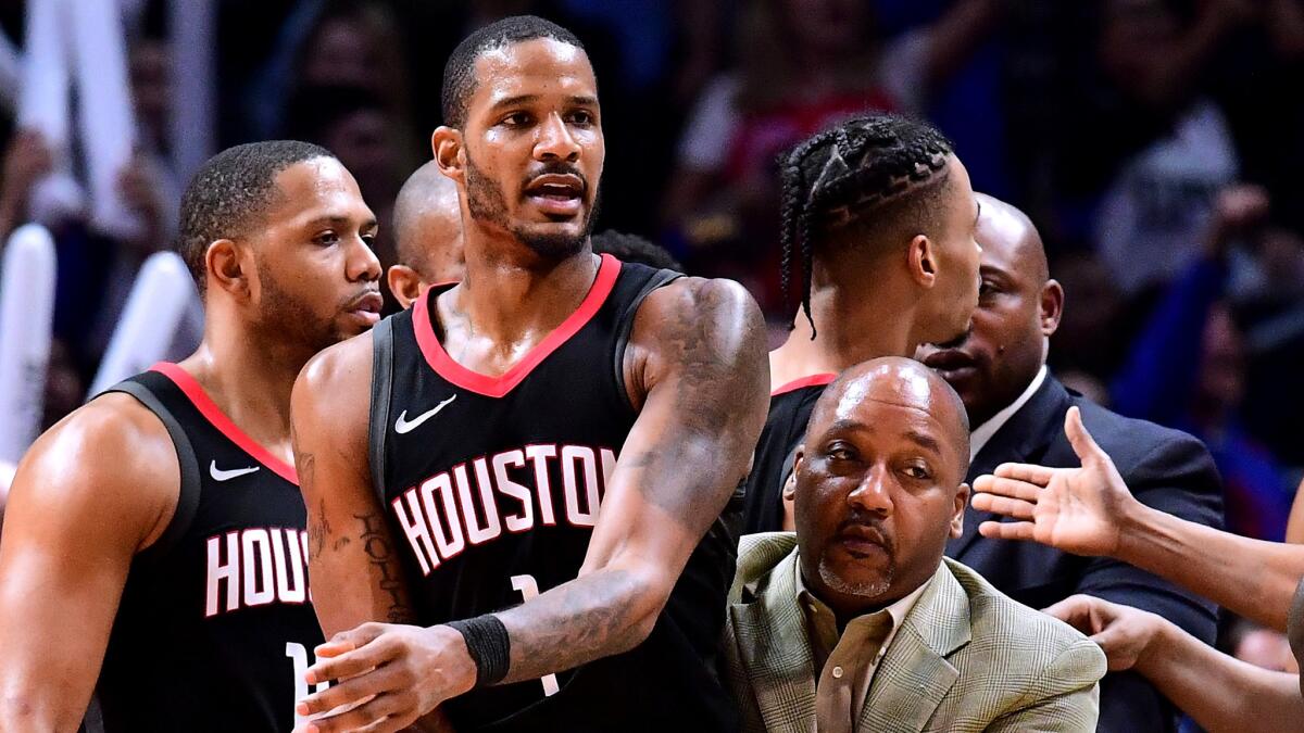 Rockets forward Trevor Ariza is restrained during an on-court scuffle against the Clippers on Monday night. He was eventually ejected from the game.