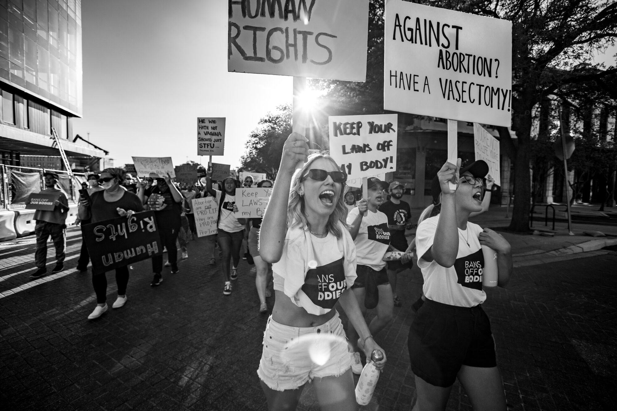 Protesters holding signs chant and march