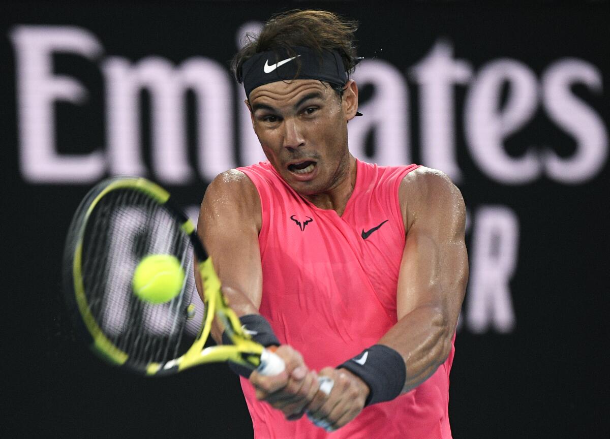 Rafael Nadal makes a backhand return.