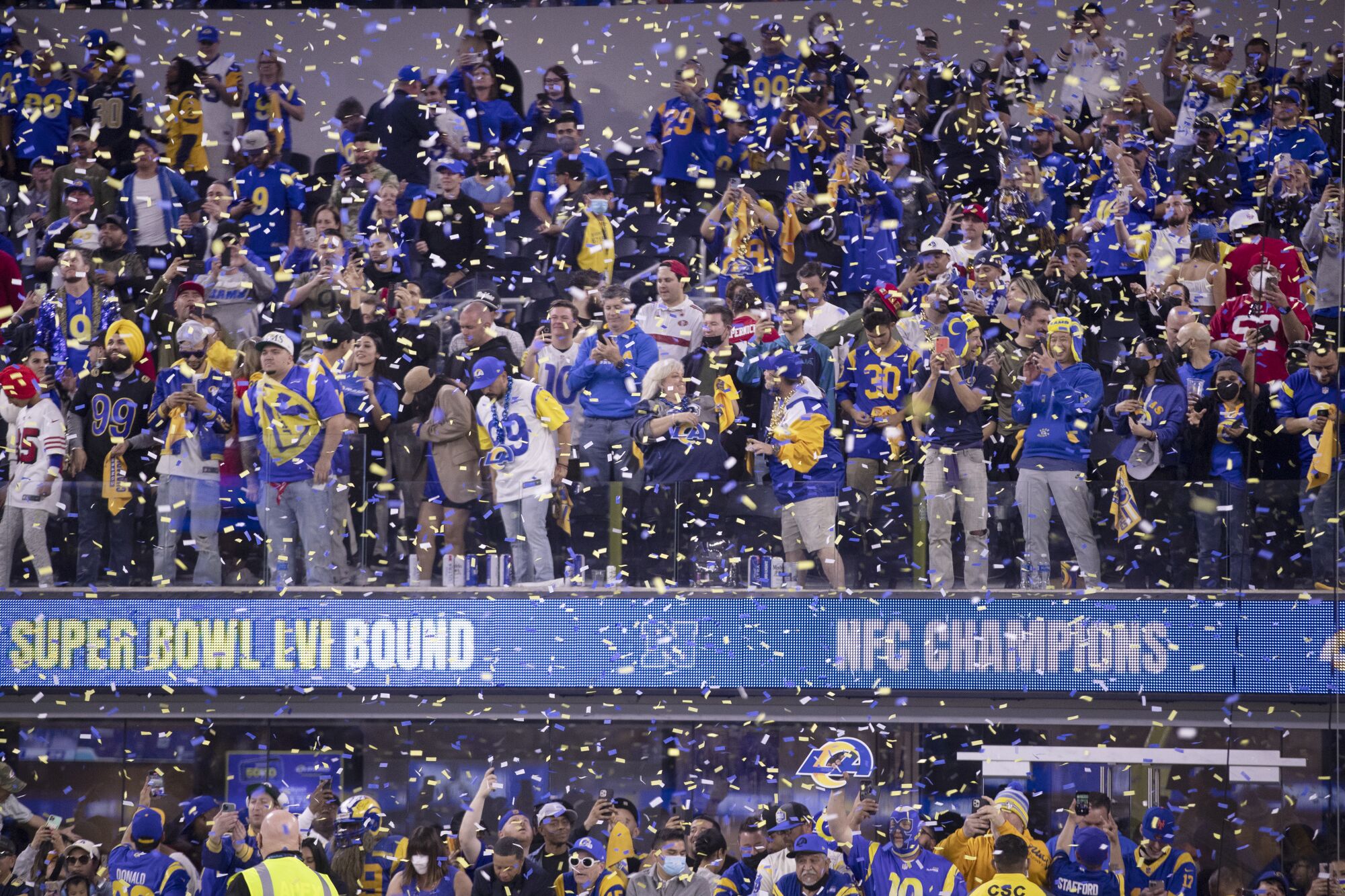 Confetti rains down at SoFi Stadium as fans celebrate the Rams' 20-17 victory over the San Francisco 49ers.