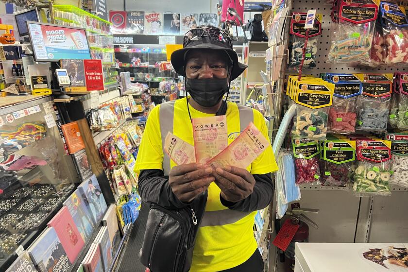Chevy Johnson, a resident of Broward County, Fla., holds the three Powerball tickets she purchased in the hope of winning the jackpot of over $1 billion, in Fort Lauderdale, Fla., on Monday, Oct. 2, 2023. She said a win would make her "the happiest person in the world." (AP Photo/Daniel Kozin)