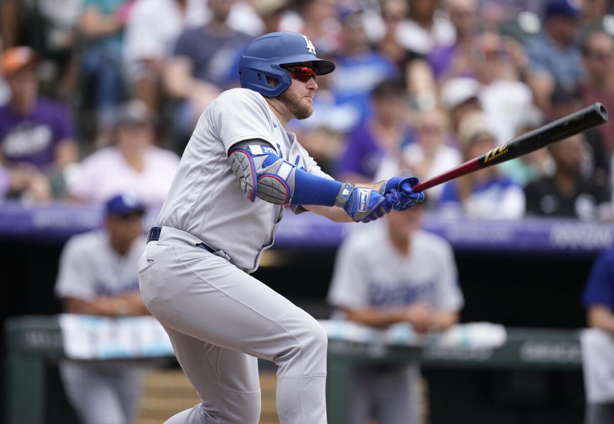 Max Muncy hits a sacrifice fly during the Dodgers' win over the Colorado Rockies.