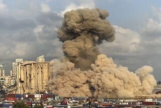 This image from a video, shows smoke and dust rising from collapsing silos damaged during the August 2020 massive explosion in the port, in Beirut, Lebanon, Tuesday, Aug. 23, 2022. The ruins of the Beirut Port silos' northern block that withstood a devastating port explosion two years ago has collapsed. The smoldering structure fell over on Tuesday morning into a cloud of dust, leaving the southern block standing next to a pile of charred ruins. (AP Photo)
