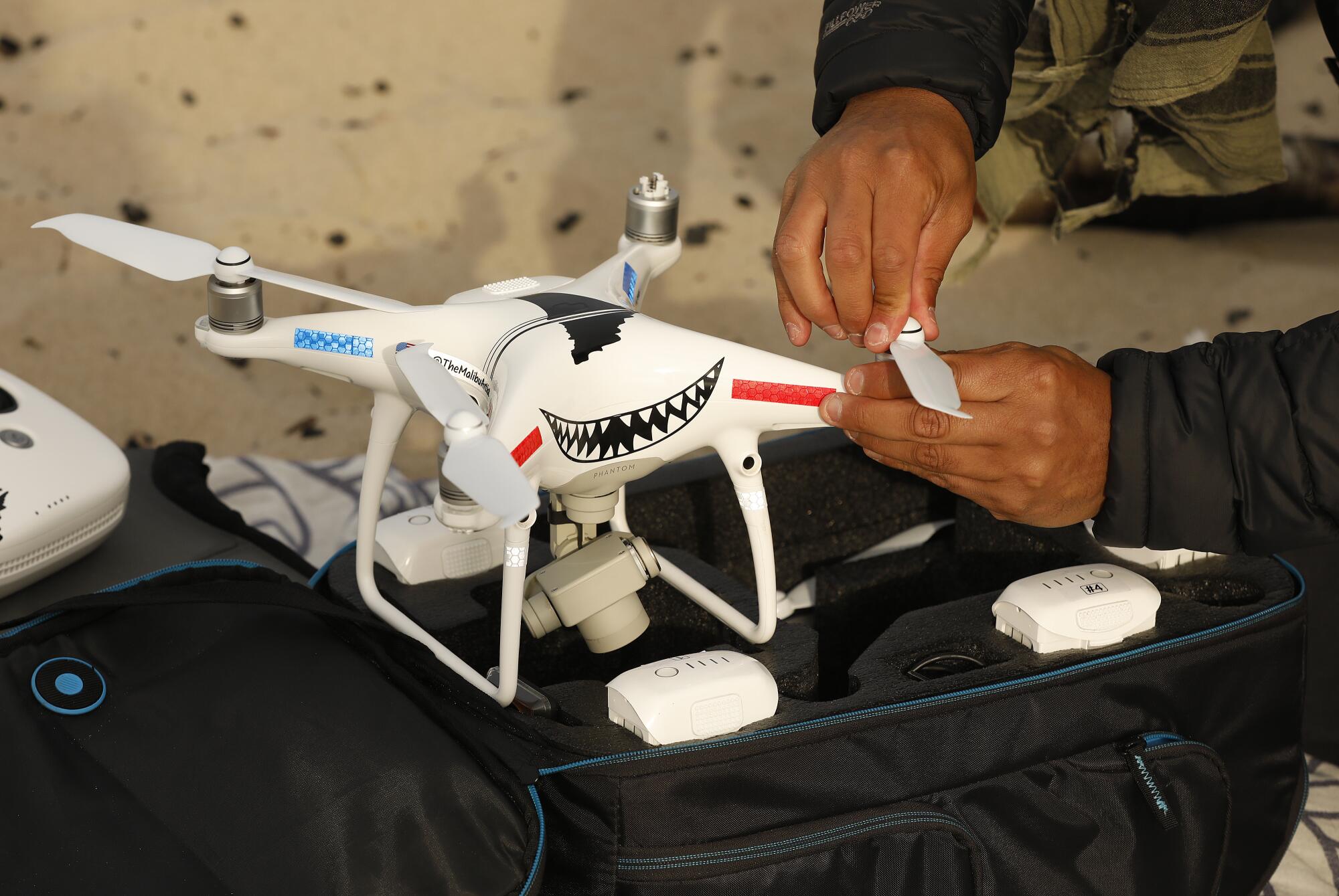 Carlos Gauna prepares a drone for launch