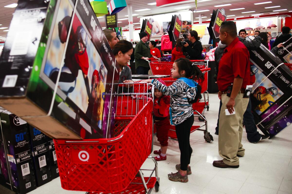 Black Friday shoppers are shown at a Target store in 2012. Target will open its doors on Thanksgiving this year.