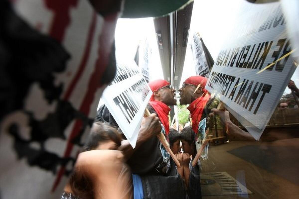 Protesters at the entrance of the Anaheim Police Department headquarters during a rally on Sunday against police shootings.