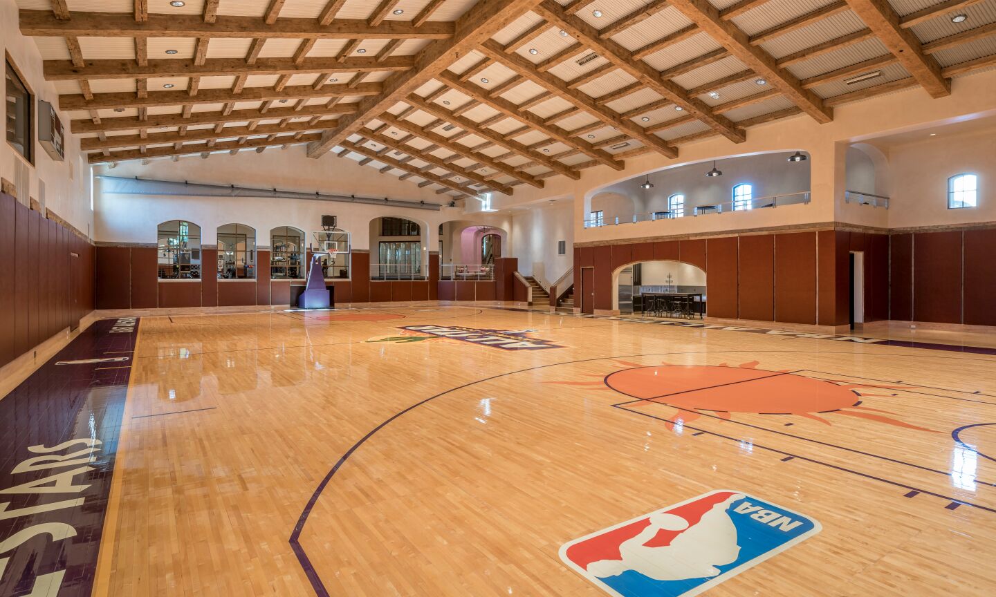 An indoor Phoenix Suns-themed basketball court.