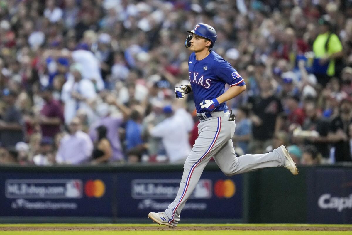 Texas Rangers star Corey Seager rounds the bases after hitting a two-run home run against the Diamondbacks.
