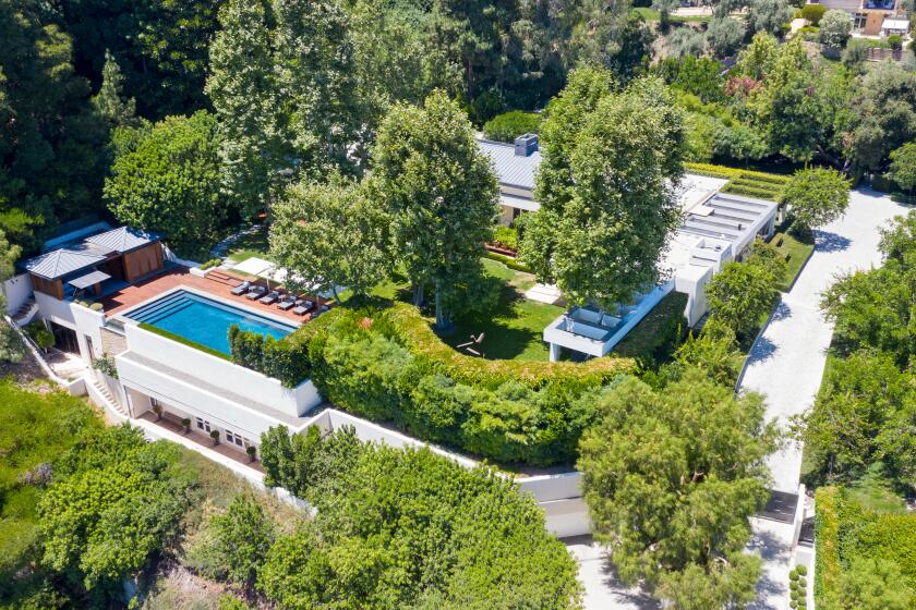 The contemporary compound includes a 9,000-square-foot mansion, two guesthouses, a pool house, swimming pool and reflecting pond.
