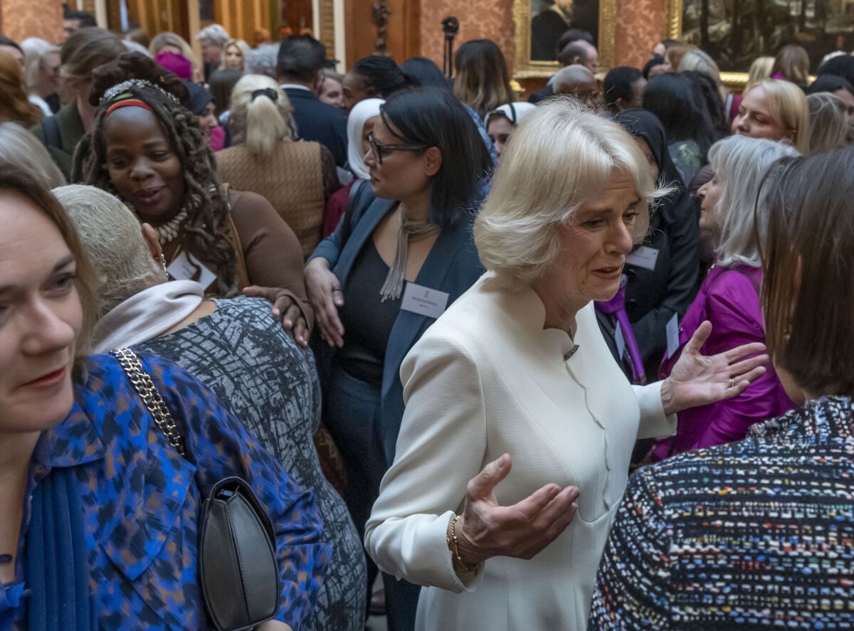 FILE - Charity leader Ngozi Fulani, centre left, attends a reception held by Britain's Camilla, the Queen Consort to raise awareness of violence against women and girls as part of the UN 16 days of Activism against Gender-Based Violence, in Buckingham Palace, in London, Tuesday Nov. 29, 2022. An honorary member of the Buckingham Palace household has resigned after repeatedly asking a Black woman who runs a charity for survivors of domestic abuse what country she “really came from.’’ The conversation was detailed on Twitter by Ngozi Fulani, chief executive of Sistah Space, an east London refuge that provides specialist support for women of African and Caribbean heritage. (AP Photo/Kin Cheung, Pool, File)