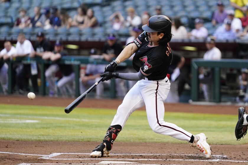 Arizona Diamondbacks' Corbin Carroll hits an RBI single against the Colorado Rockies during the first inning of a baseball game Wednesday, May 31, 2023, in Phoenix. (AP Photo/Ross D. Franklin)