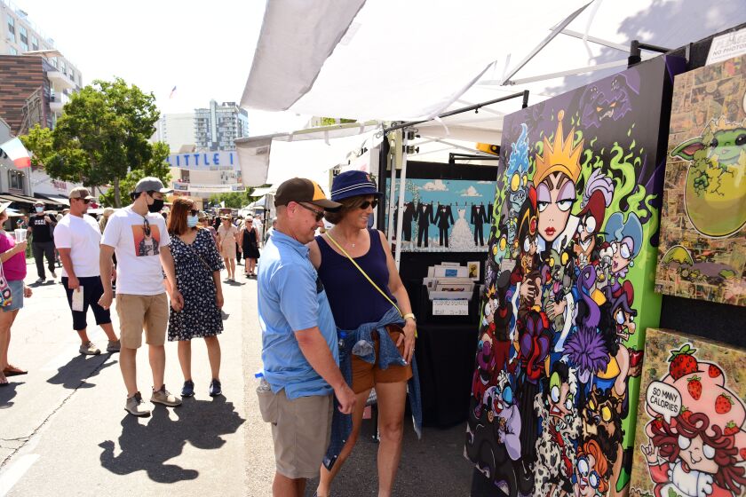 Folks check out artist booths at a previous Mission Fed ArtWalk Little Italy event.