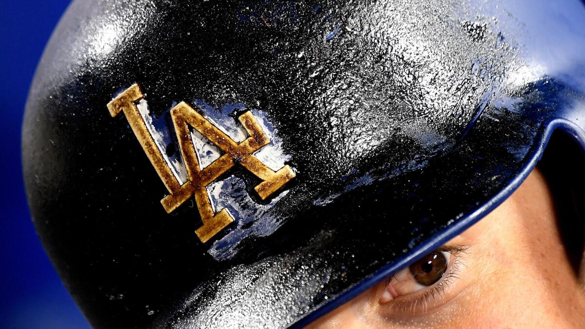 With pine tar covering his helmet, Dodgers Yasmani Grandal preapres to bat at Dodger Stadium.