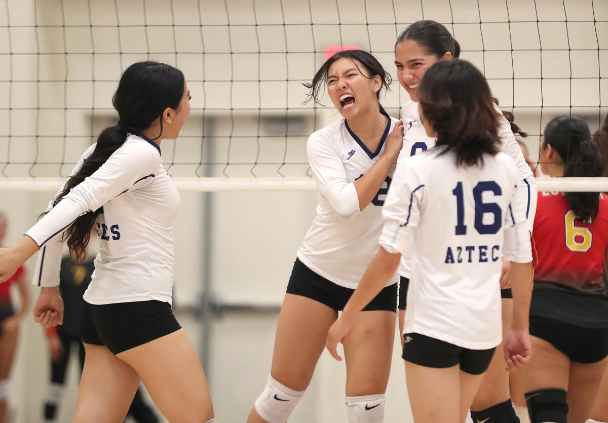 La Quinta's Evangeline Vo (18) reacts to winning a long rally for a point against Estancia on Tuesday.