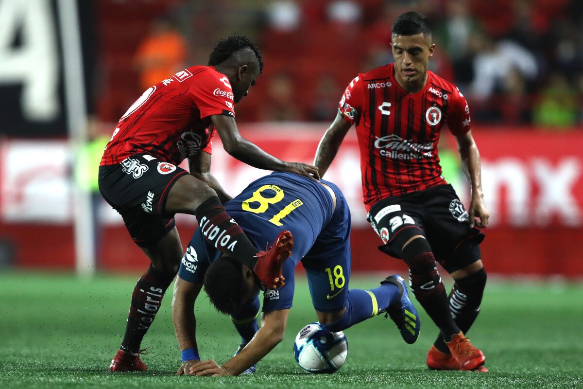 Argentine midfielder Leonel Miranda (right), shown here with Miller Bolanos (left) and Boca Junior's Frank Fabra in a preseason exhibition July 10, is one of several new players for the Tijuana Xolos.