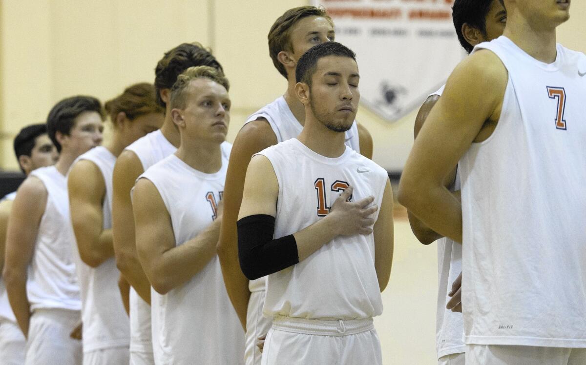 Ivan Garcia-Burgos, who closes his yes and places his hand over his heart during the national anthem recently, has been an inspiration for the Orange Coast College men's volleyball team after surviving cancer since being diagnosed two years ago.