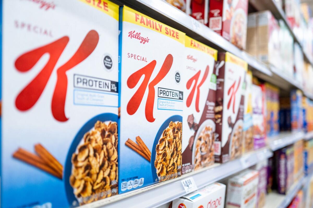 Boxes of Kellogg's and other cereals lined up on grocery store shelves