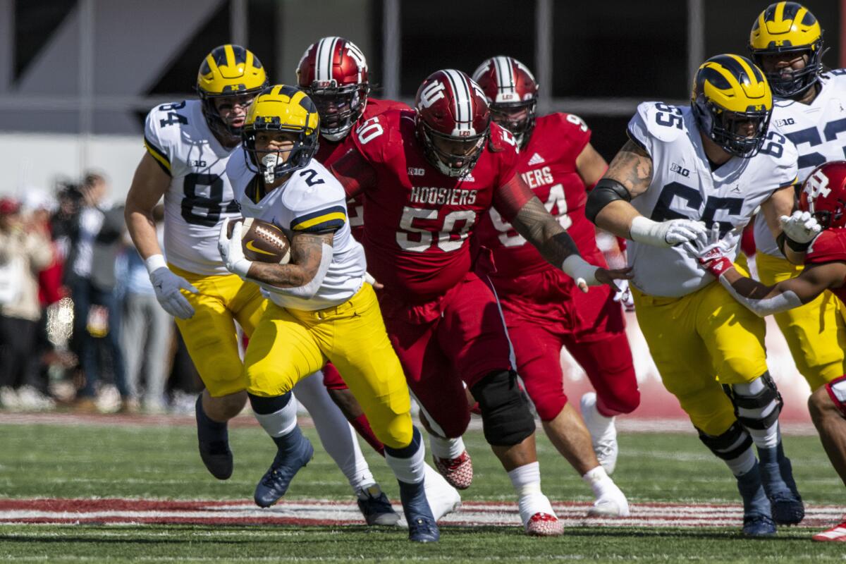 Michigan running back Blake Corum (2) runs the ball out of the backfield during the first half of an NCAA college football game against Indiana, Saturday, Oct. 8, 2022, in Bloomington, Ind. (AP Photo/Doug McSchooler)