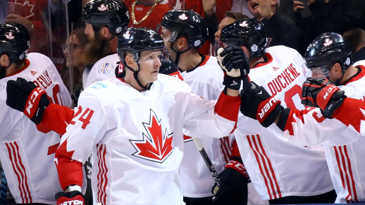 Team Canada winger Corey Perry is congratulated by teammates after scoring against Team USA at the World Cup of Hockey in Toronto on Sept. 20.