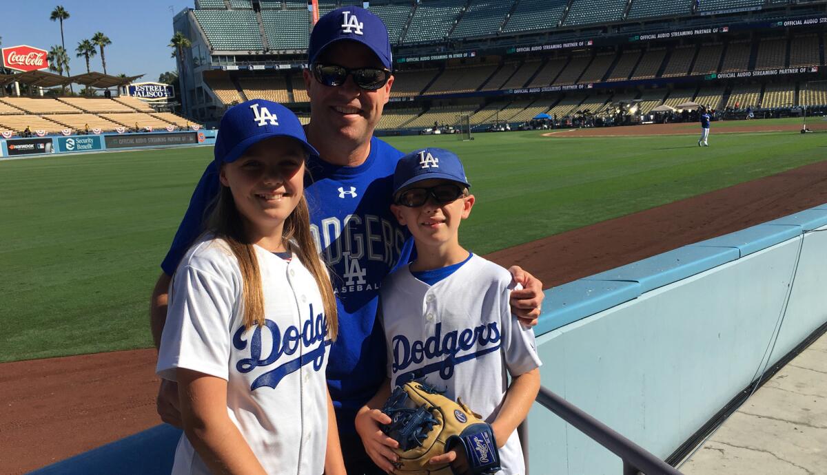Ryan, left, Pat and Sean Gilhooly along the left-field line at Dodger Stadium on Saturday.
